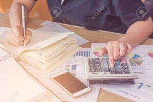 manos sosteniendo calculadora y documentos legales